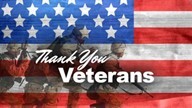 The American flag with the words Thank You Veterans, while soldiers run in the background.