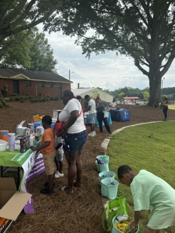 Families browsing tables and booths outside. 